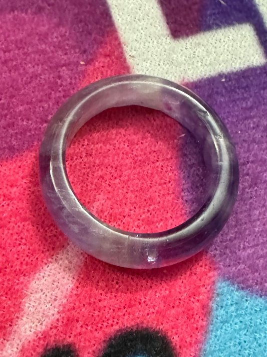 Amethyst ring on a colorful fabric background