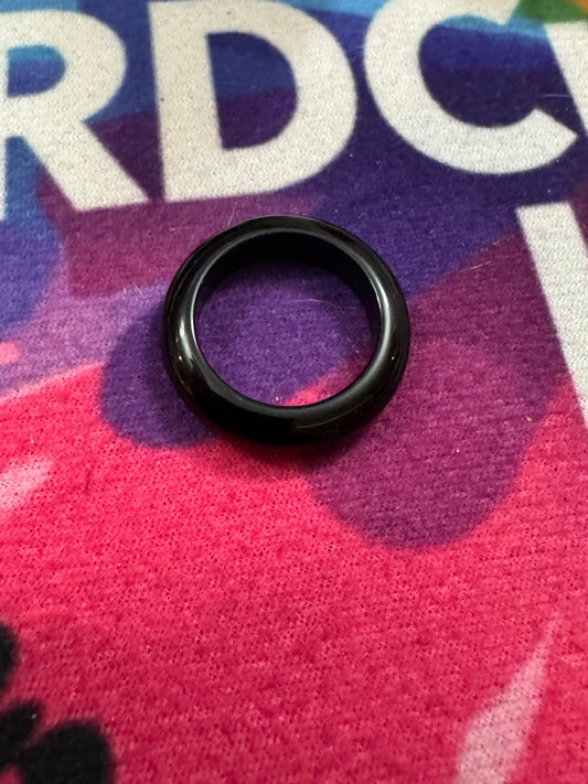 Black Obsidian ring on a colorful fabric background 