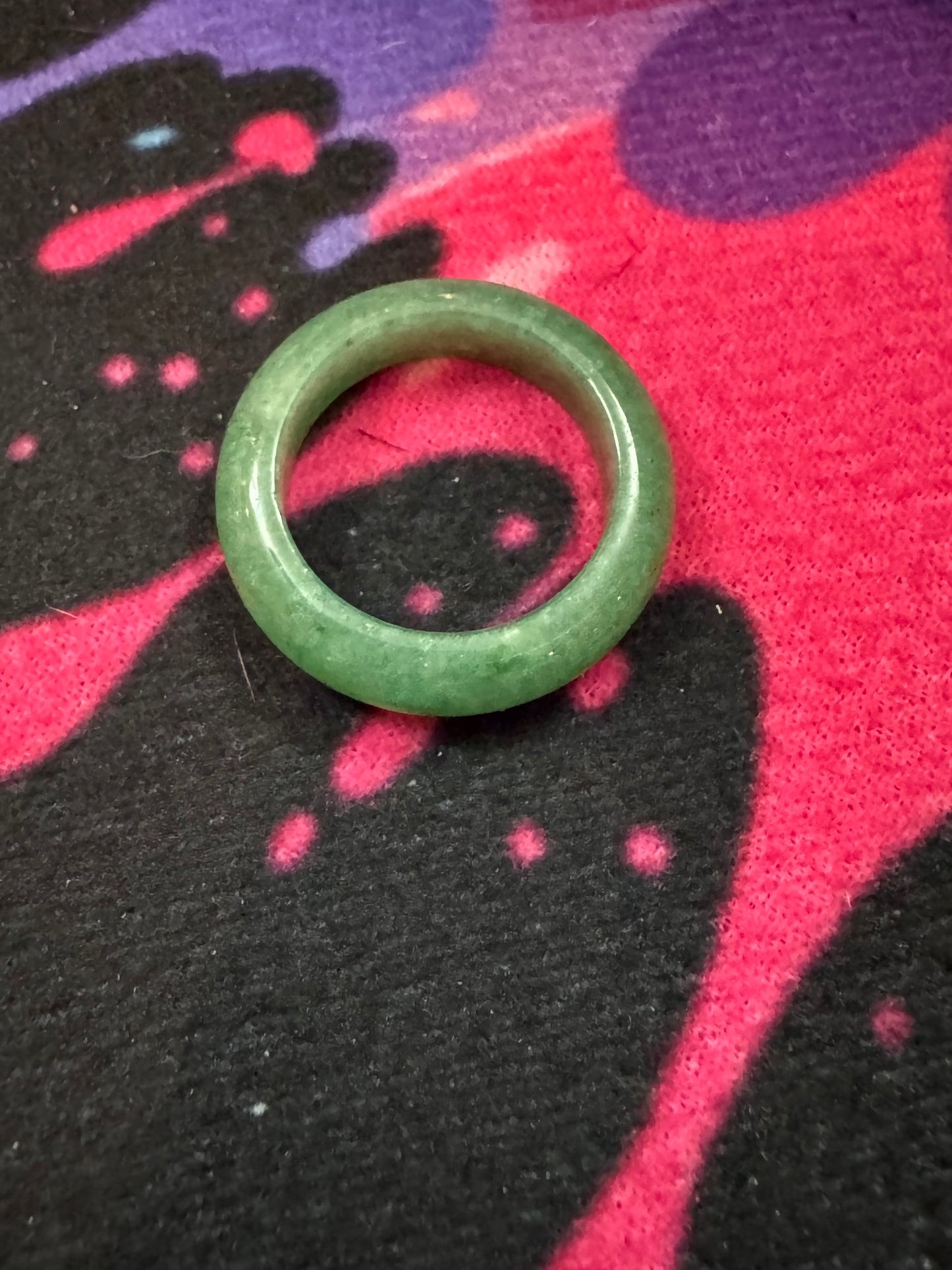 Green Aventurine ring on a colorful fabric background