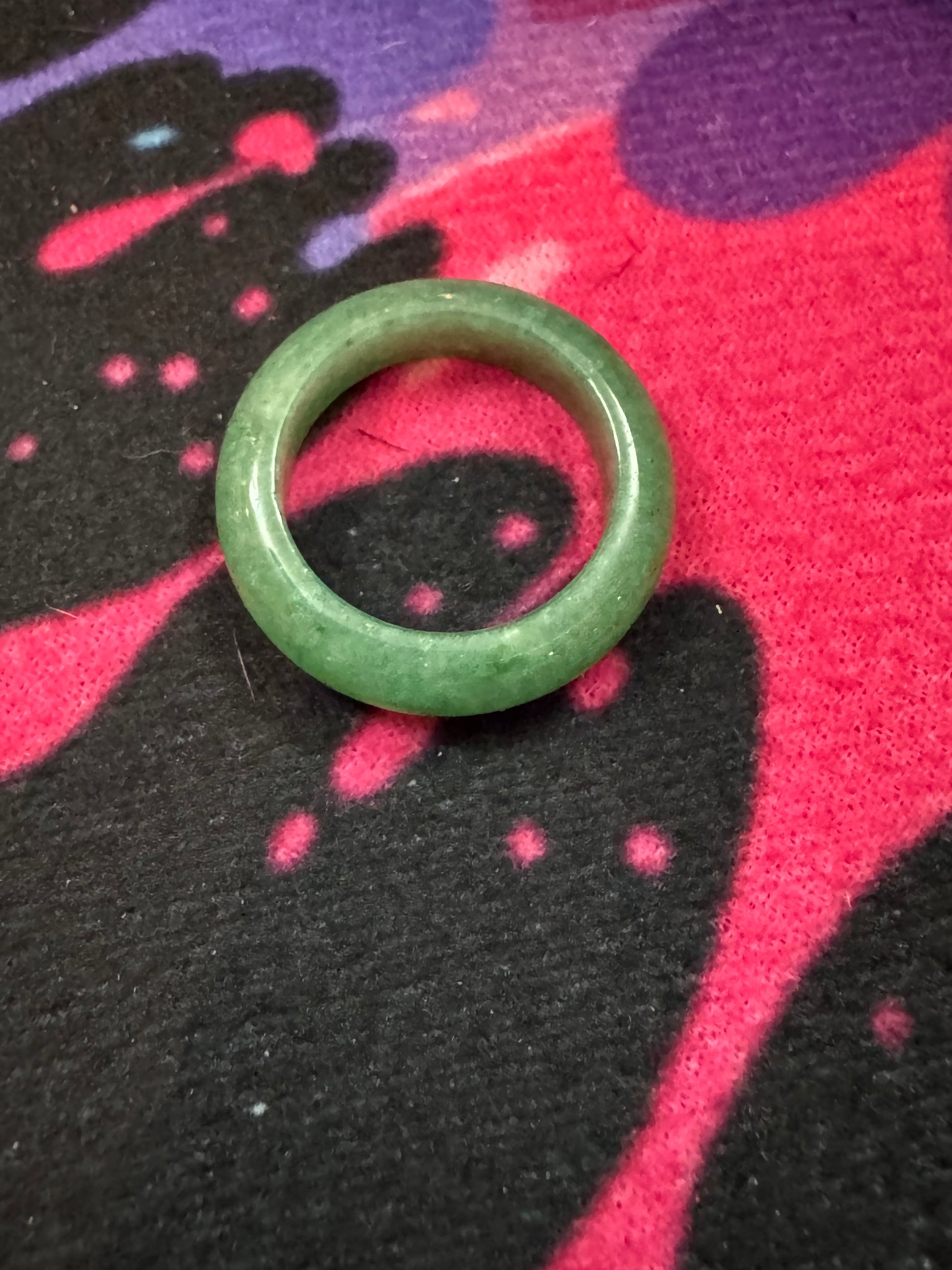 Green Aventurine ring on a colorful fabric background