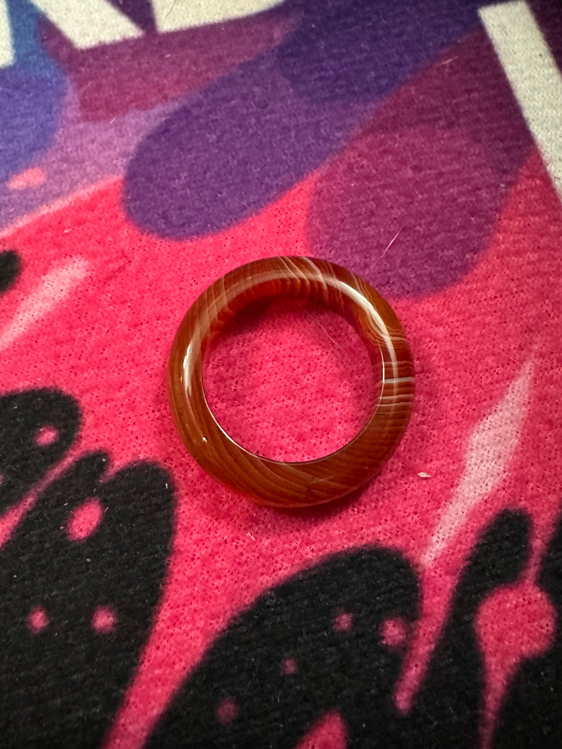 Carnelian ring on a colorful fabric background