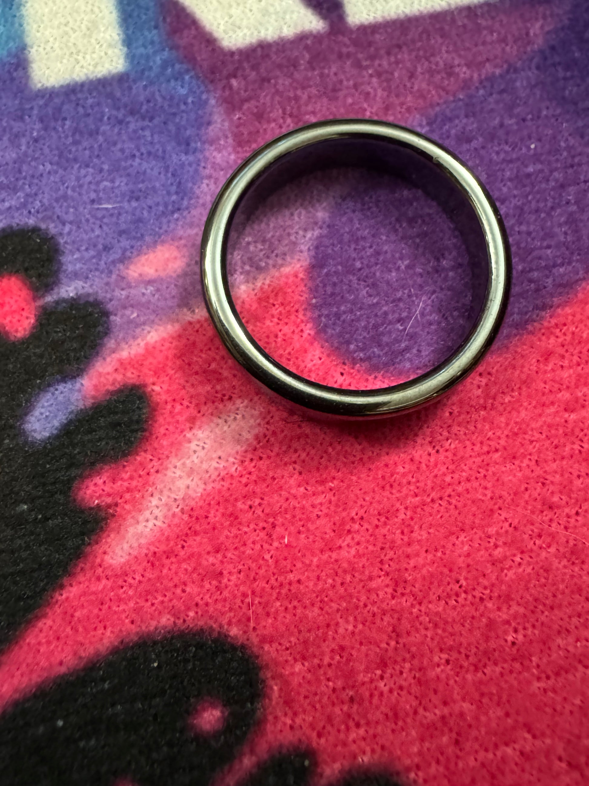 Hematite ring on a colorful fabric background