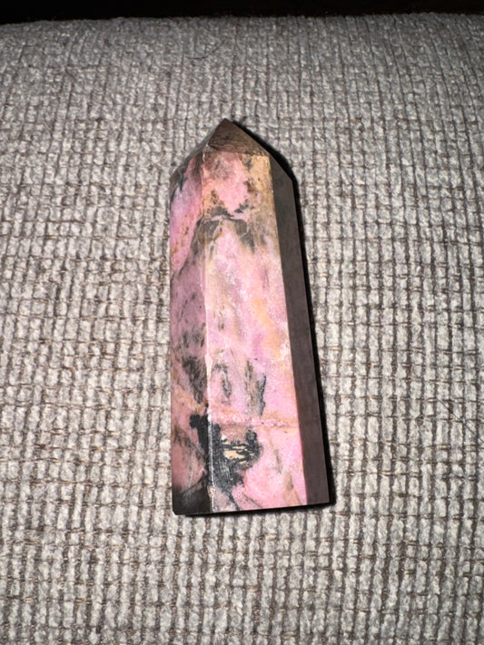 Pink crystal tower on a textured surface