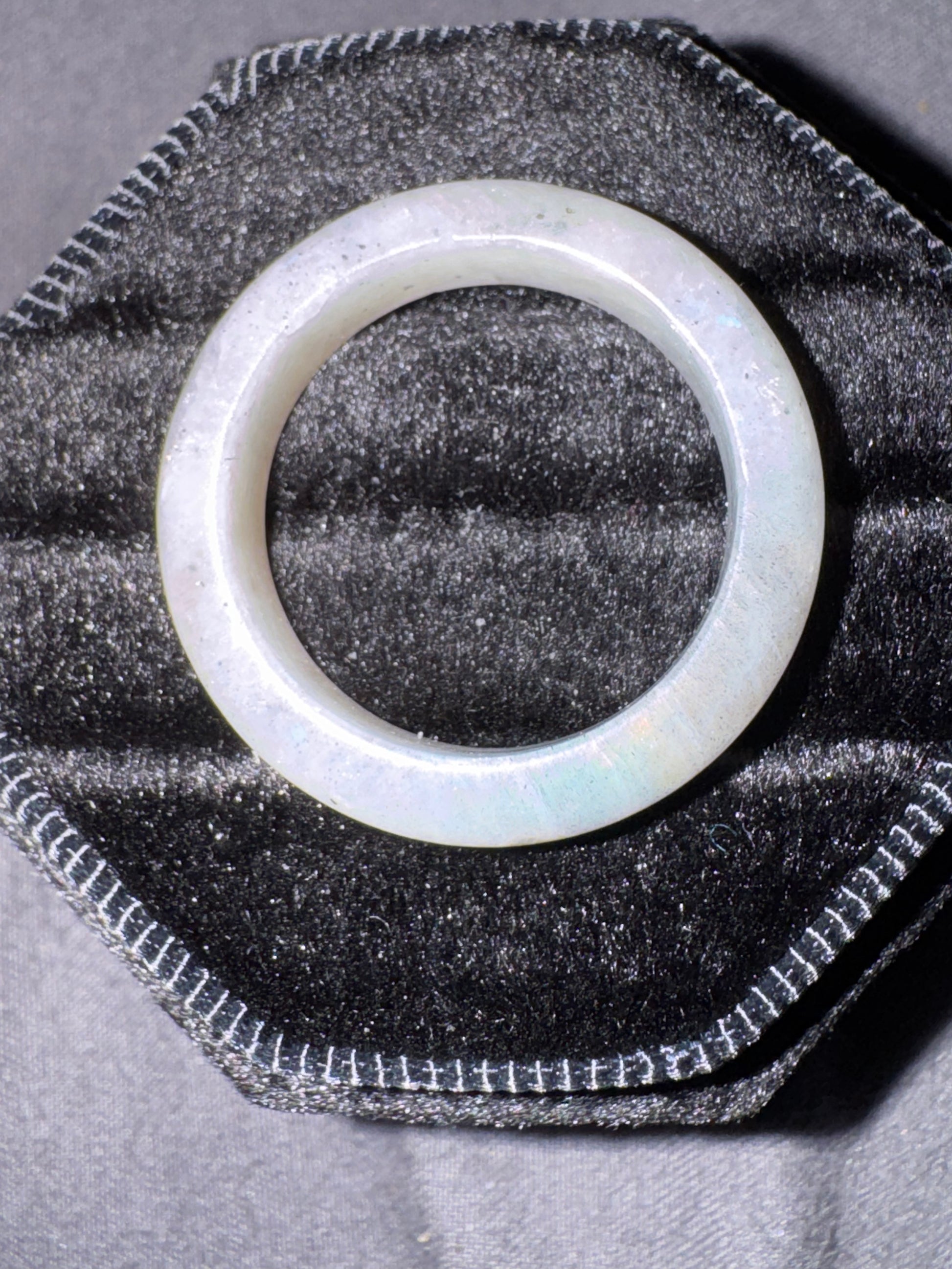 Translucent  ring on a textured black surface