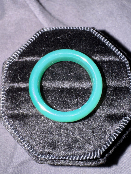Turquoise o-ring on a textured gray background
