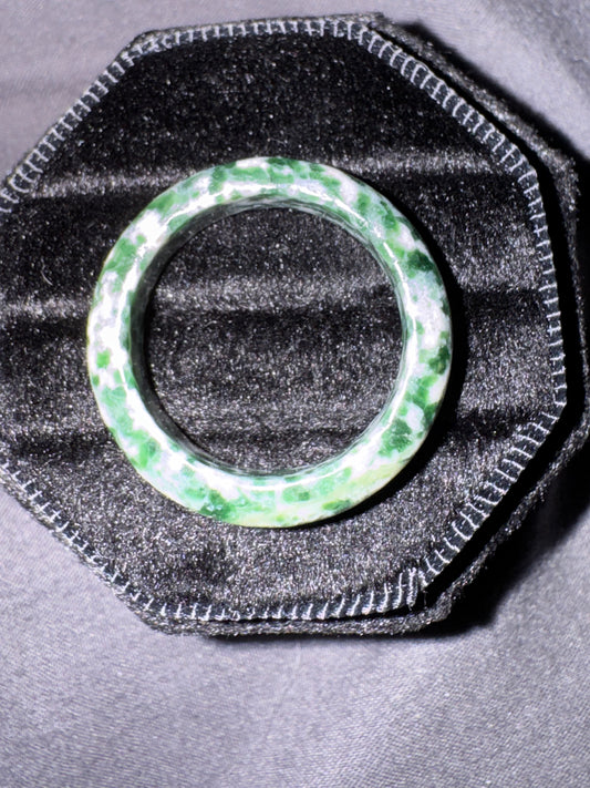 Green ring on a textured black stand