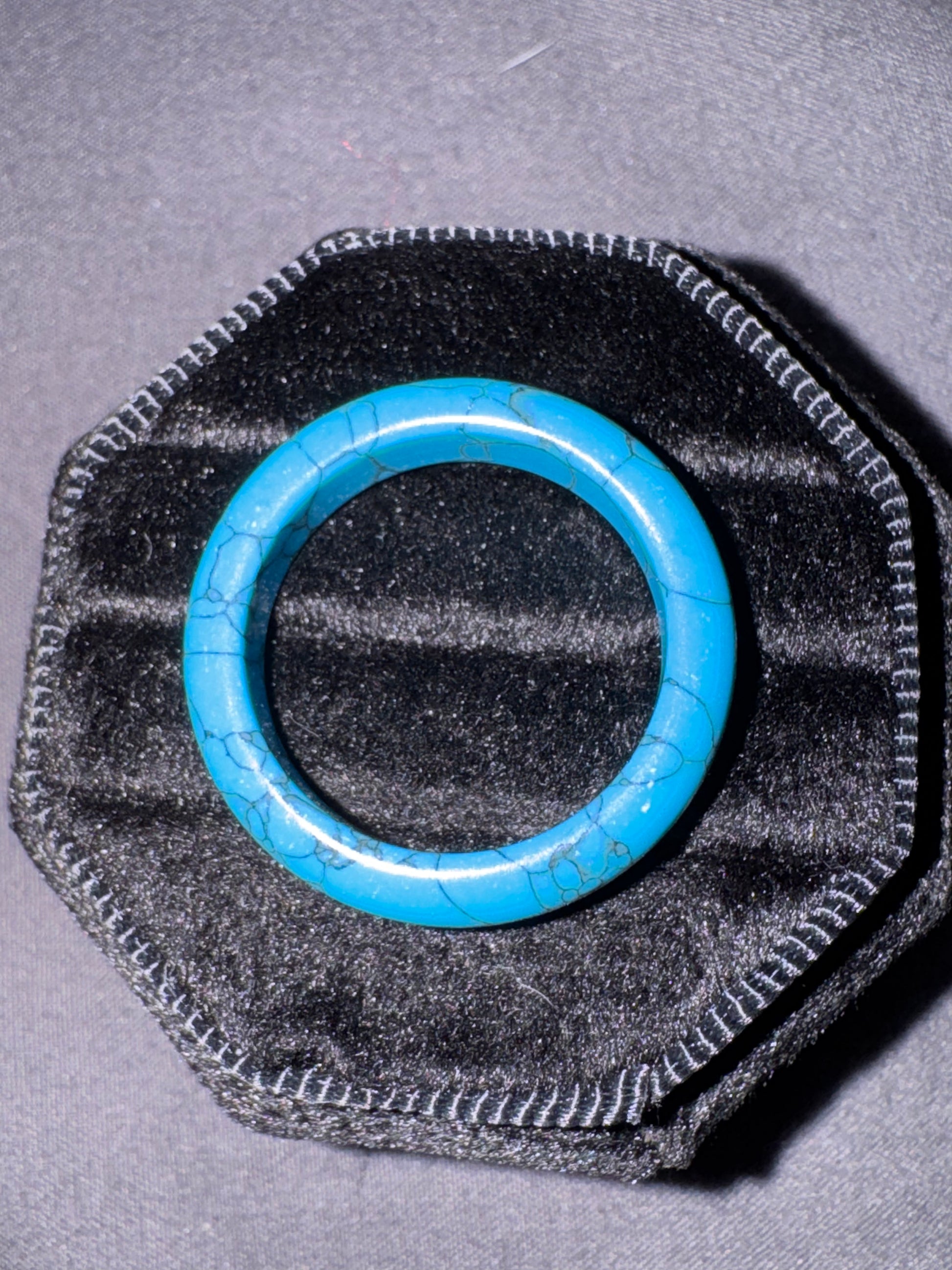 Blue ring on a textured black and gray background