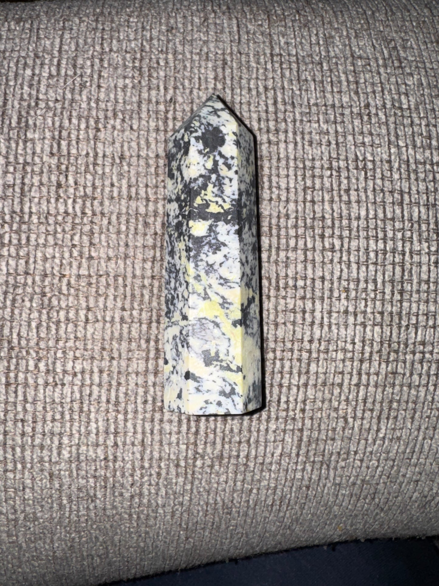 Decorative stone on a textured fabric surface