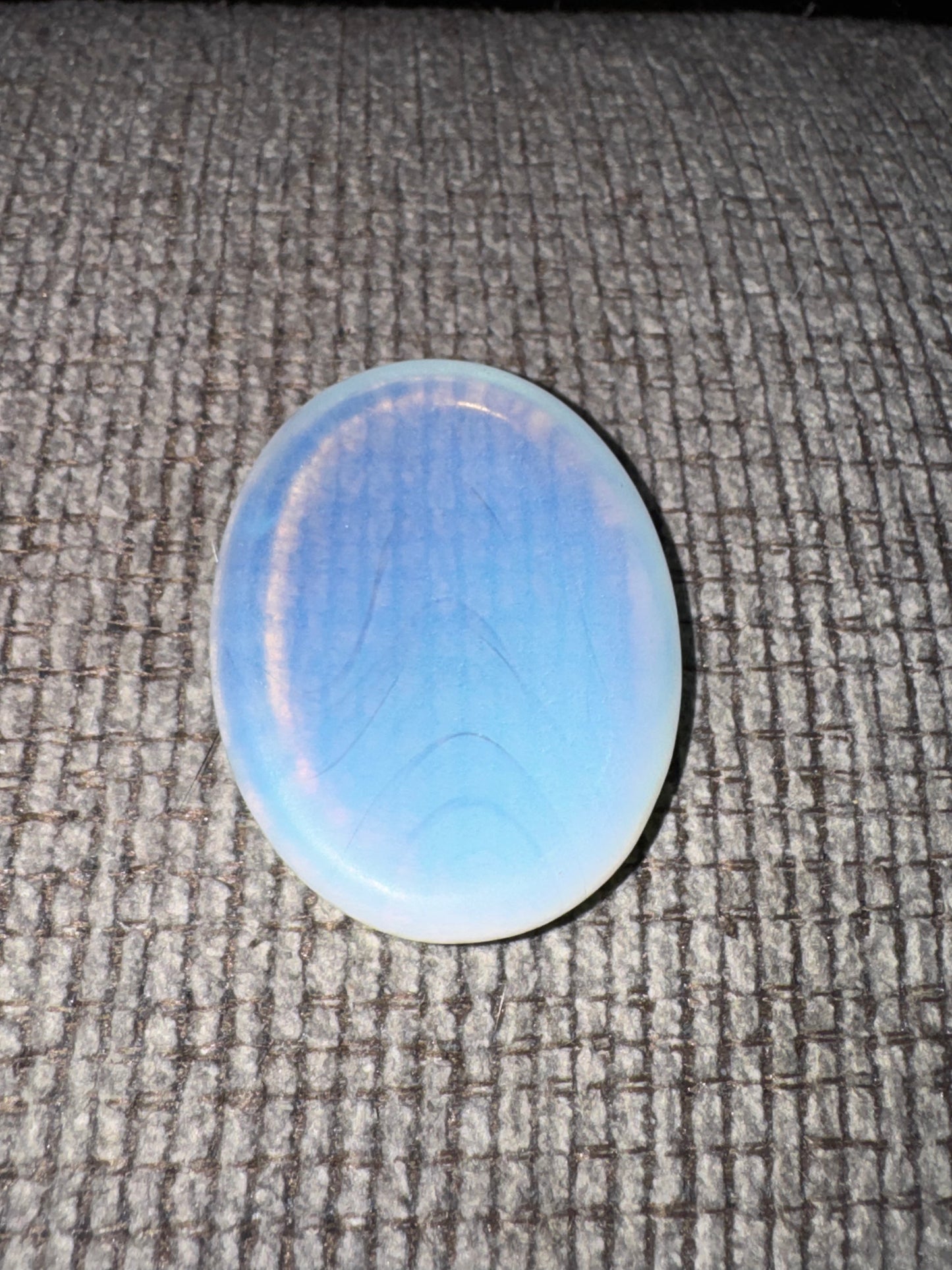 Opal stone on a textured gray surface