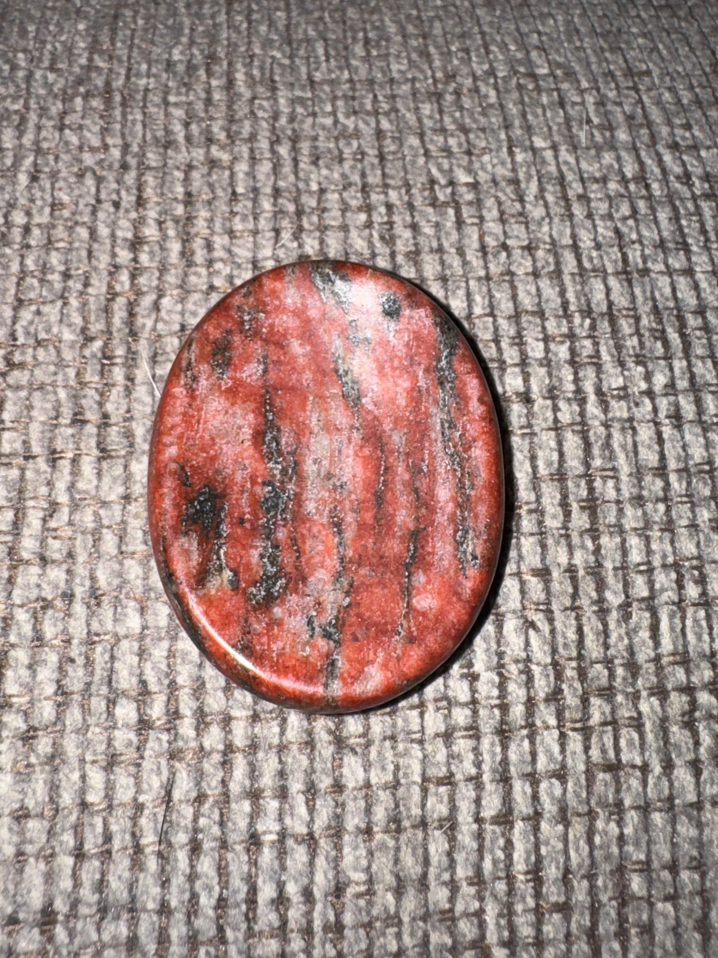 Red stone on a textured gray surface
