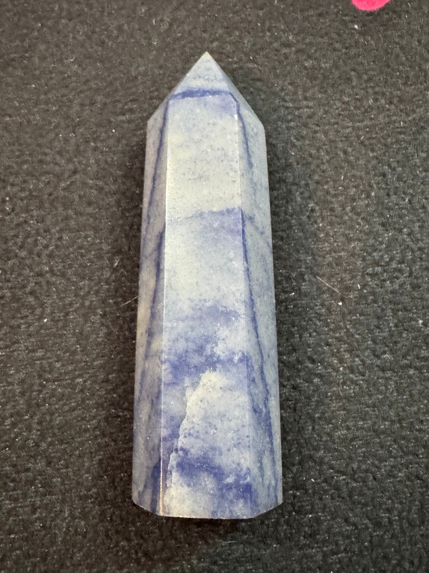 Blue and white striped crystal on a black background
