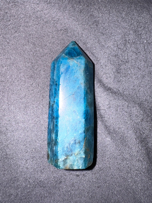 Blue crystal on a gray fabric background