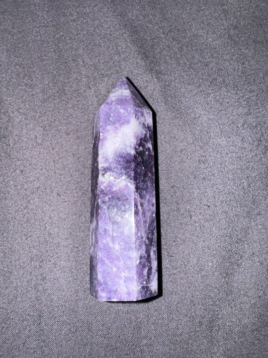 Purple crystal tower on a gray textured background