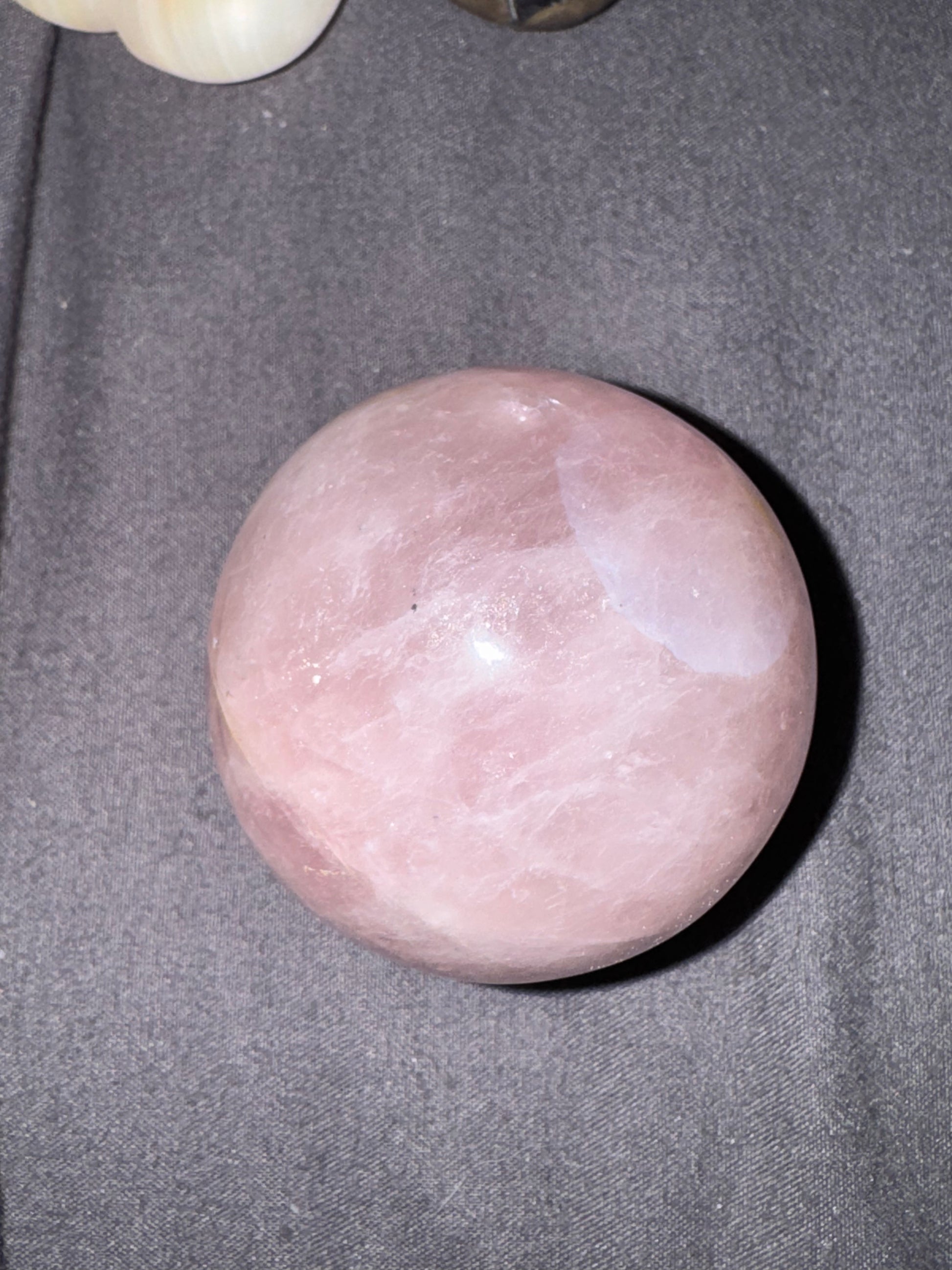 Pink stone on a gray fabric background