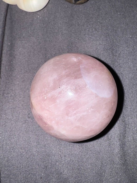 Pink stone on a gray fabric background