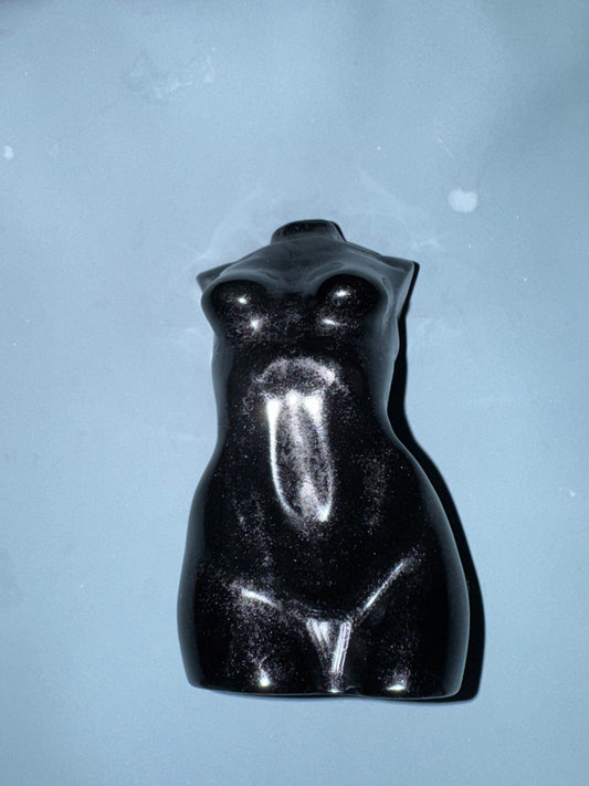 Black female sculpture on a light blue background