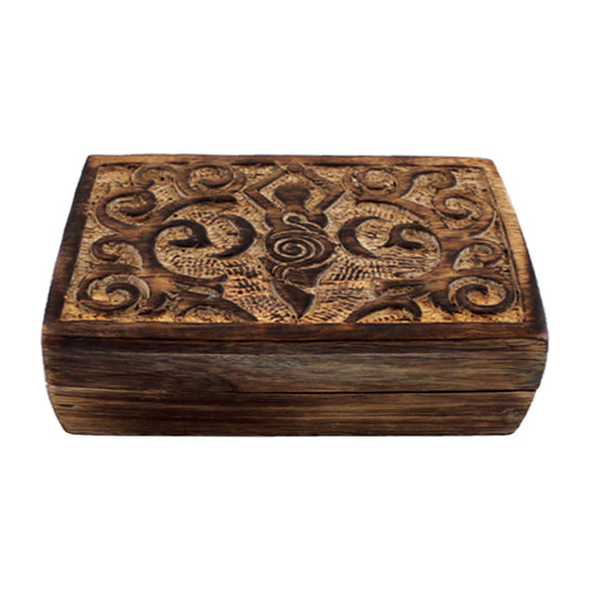 Wooden box with intricate carvings on a white background